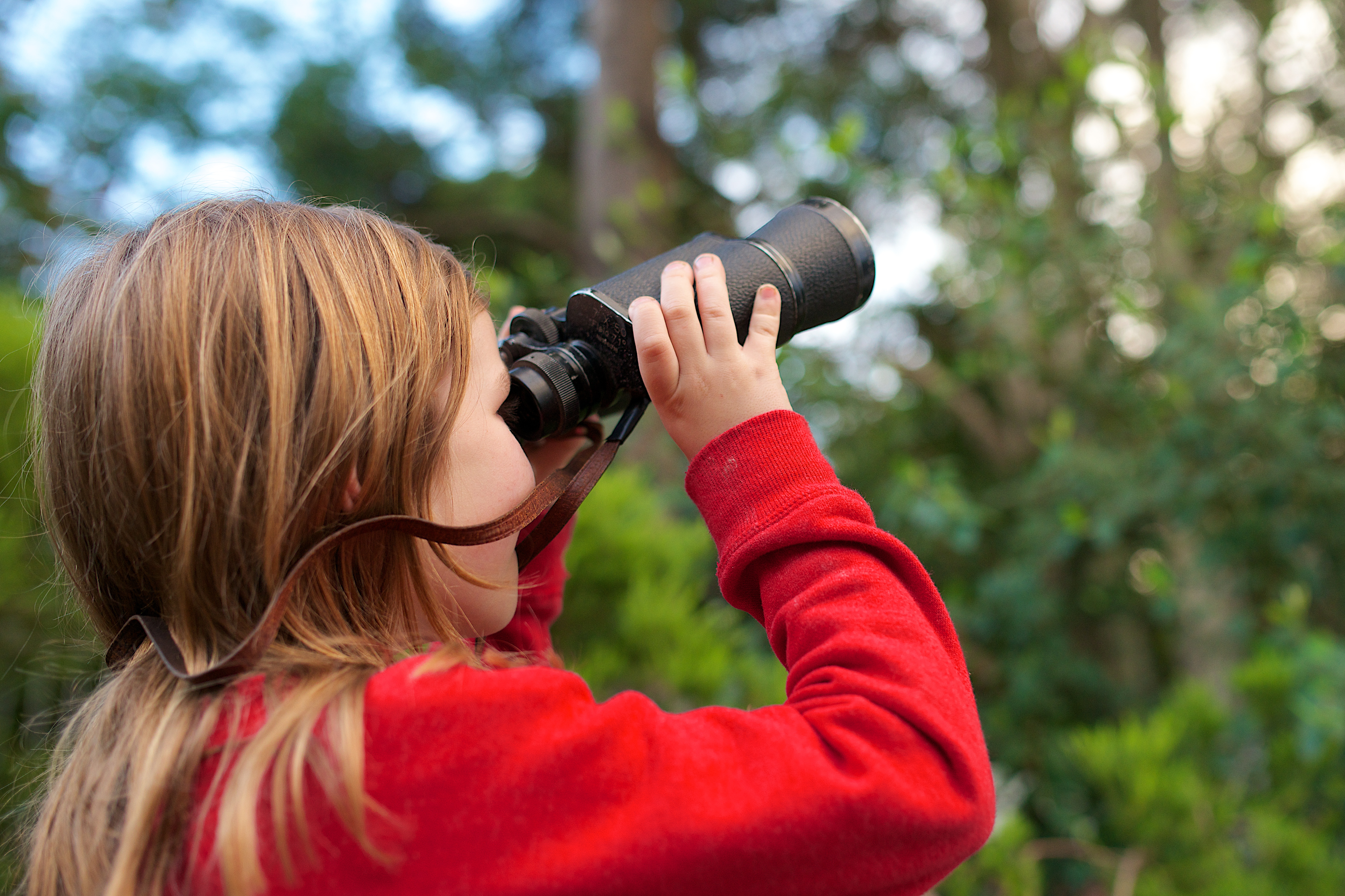 Child looking through binoculars